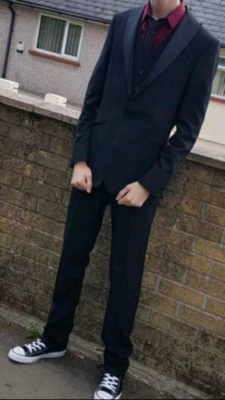 black suit with red under shirt